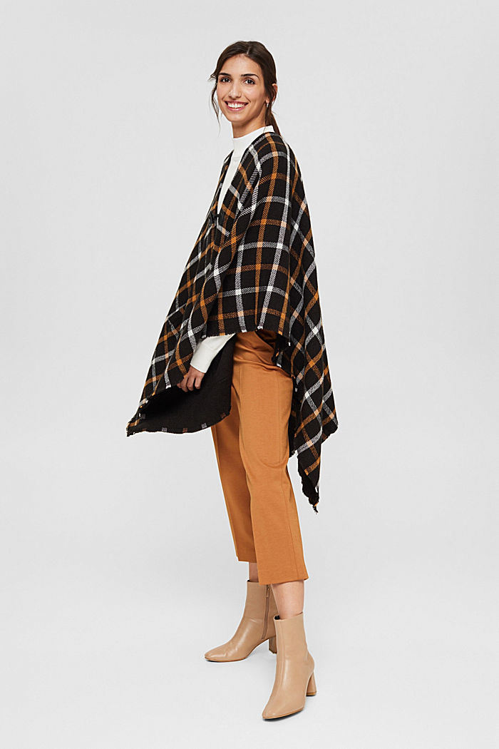 Checked poncho with a toggle fastener